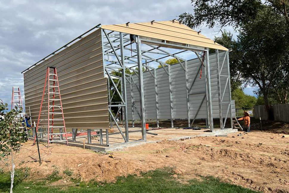 Metal garage construction by American Steel Carports