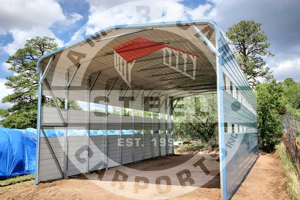 Steel carport with a blue roof and red accents, ideal for RV protection during hurricane season in the Southeast.