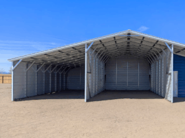 Front view of a metal barn in Arlington Heights, IL with a center enclosed garage, open lean-to sections on both sides, and a blue accent wall with a walk-in door and window.