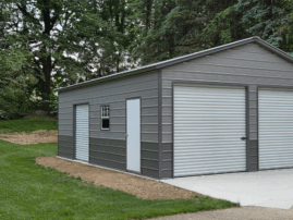 Two-car metal garage in Appleton, WI featuring pewter gray horizontal siding, two roll-up doors, and a walk-in door, built by American Steel Carports, Inc.