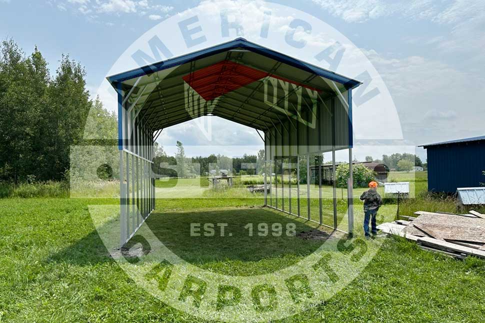 A man poses by a metal carport, highlighting steel upgrades for fall in Arkansas.